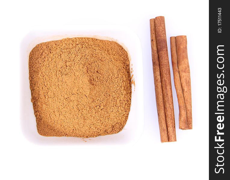 Cinnamon sticks and ground cinnamon on white background