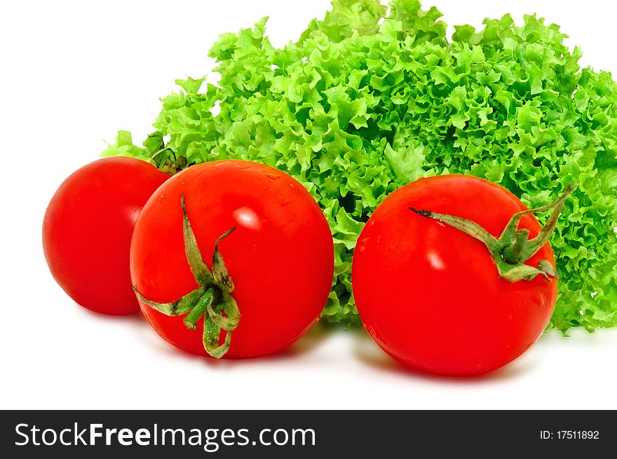 Red tomatoes and green lettuce, isolated on white