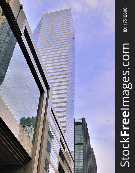 Modern buildings in Hongkong, under blue sky, with glass external and reflection, means business developing and urban environment. Modern buildings in Hongkong, under blue sky, with glass external and reflection, means business developing and urban environment.