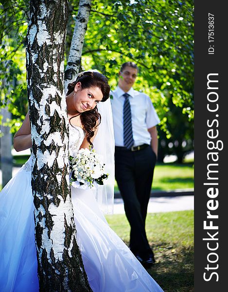 Happy bride and groom at the birches in the park