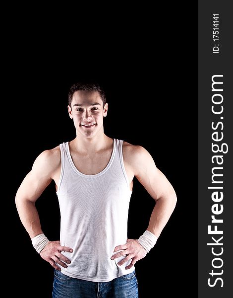 Young, fresh and strong man isolated over black background. Young, fresh and strong man isolated over black background.