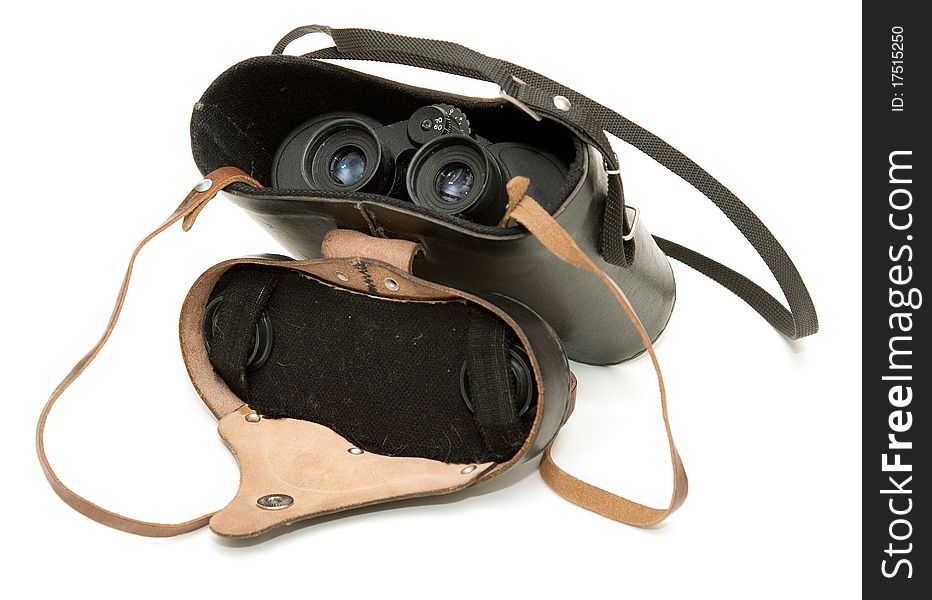 Old black binoculars in leather case on a white background