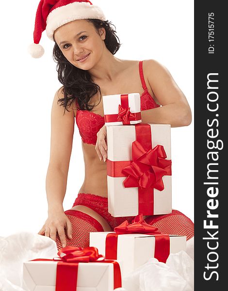 Beautiful girl wearing santa hat with many gift boxes over white. Beautiful girl wearing santa hat with many gift boxes over white