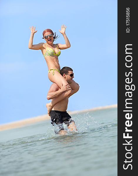 A young happy couple having fun on the beach.