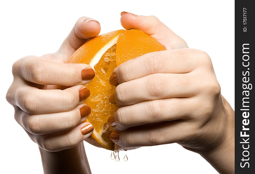 Two hands break off an orange on a part, is isolated on the white. Two hands break off an orange on a part, is isolated on the white