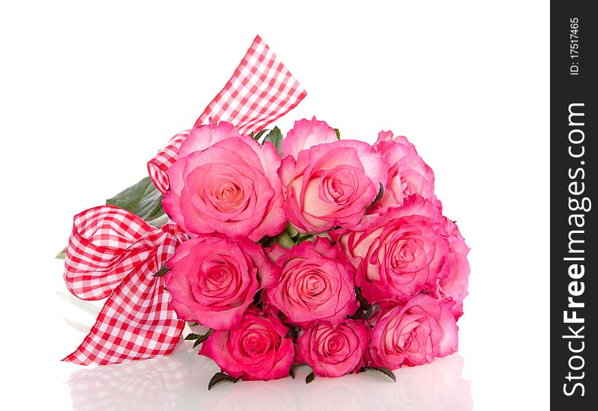 White roses with pink edges with a checkered ribbon isolated over white