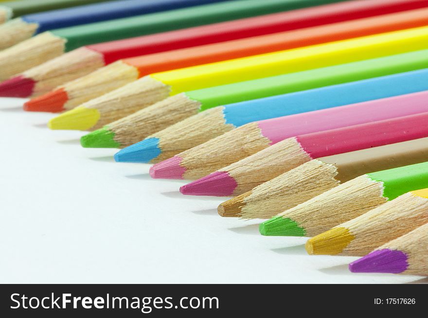 Colored pencils arranged in rainbow's colors