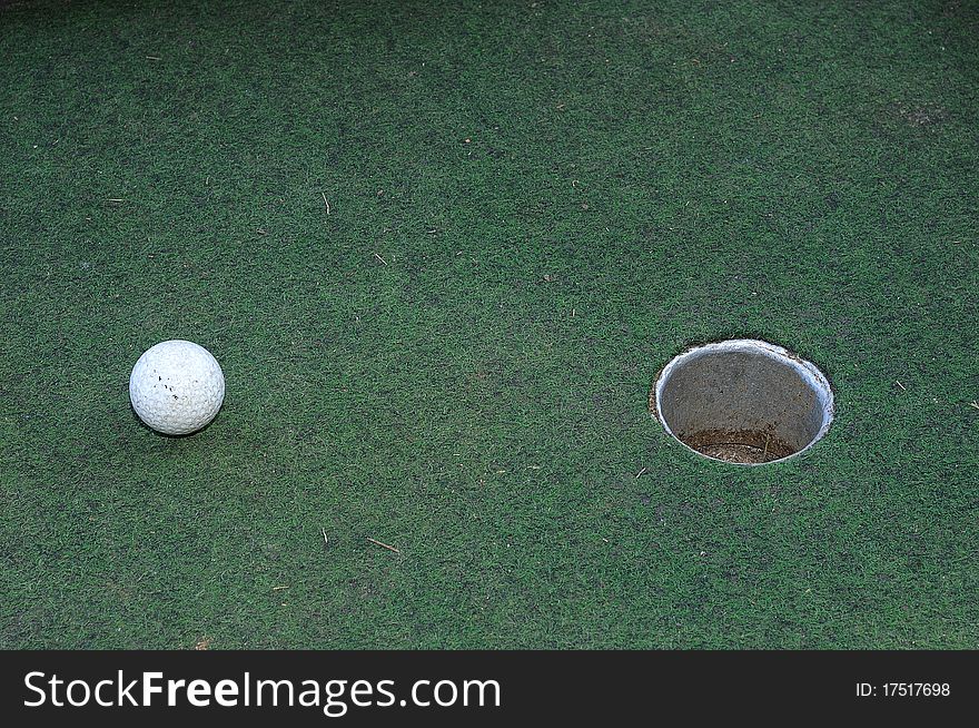 A golf ball near the hole