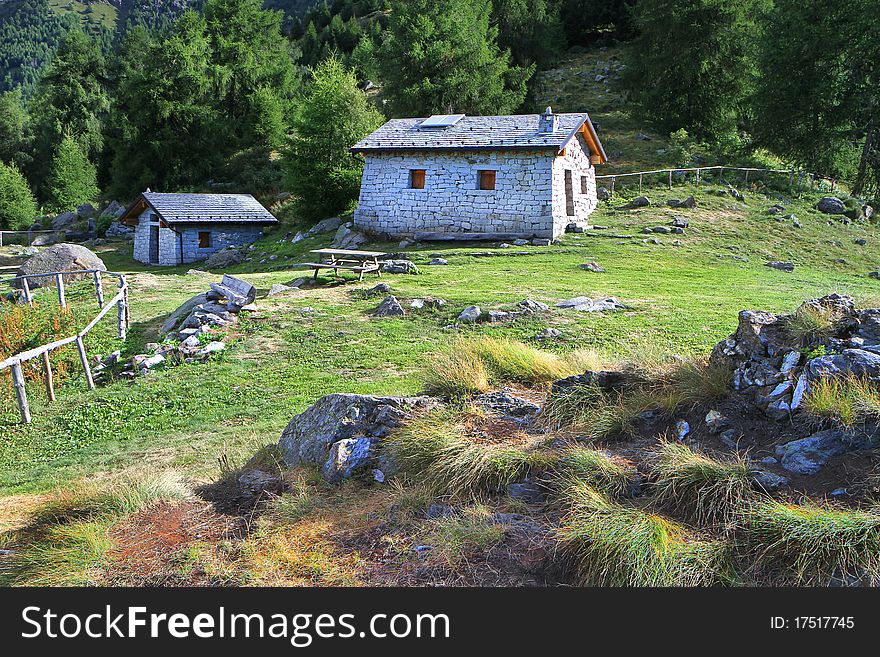 Cabins in a mountain valley in the North of Italy. Brixia province, Lombardy region, Italy