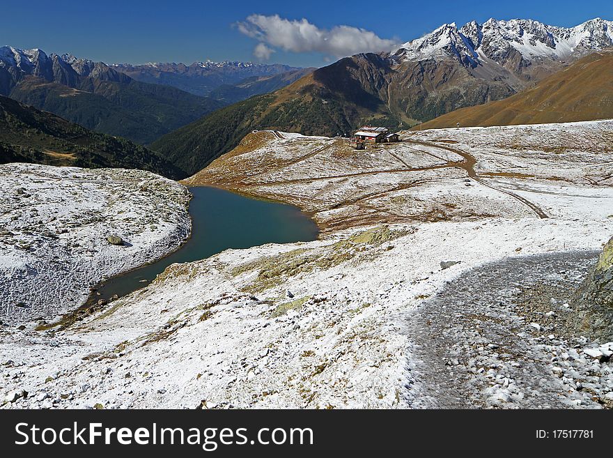 A small alpin lake at 2500 meters on the sea-level after a fall snow storm near Montozzo Pass, Brixia province, Lombardy region, Italy