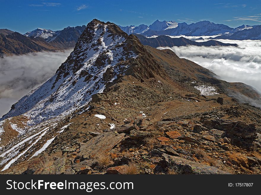 Graole Peak at 2861 meters on the sea-level. Brixia province, Lombardy region, Italy. Under, a sea of fog