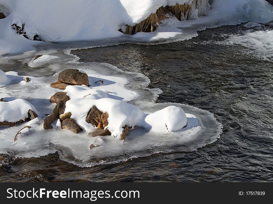 A small icy mountain torrent after a frozen winter night. Brixia province, Lombardy region, Italy. A small icy mountain torrent after a frozen winter night. Brixia province, Lombardy region, Italy