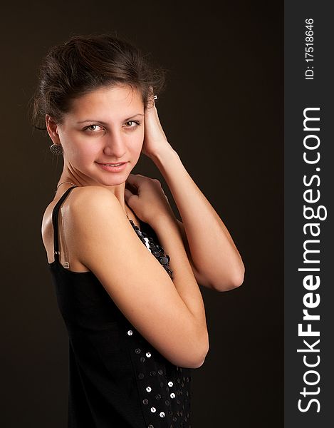 Portrait of young woman. Dark background