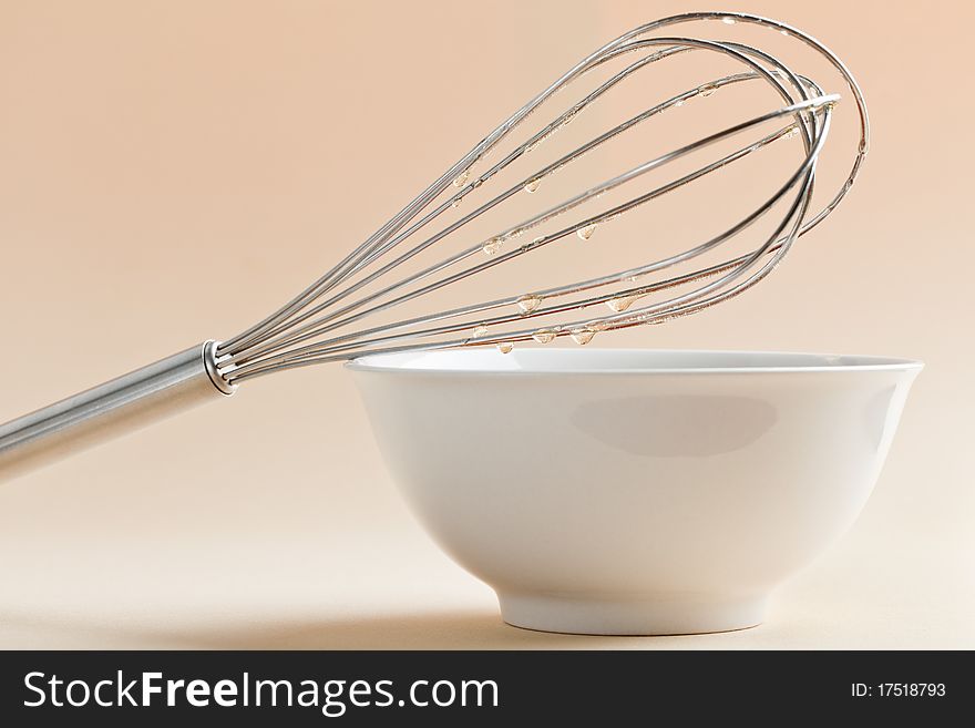 Kitchen whisk on top of bowl