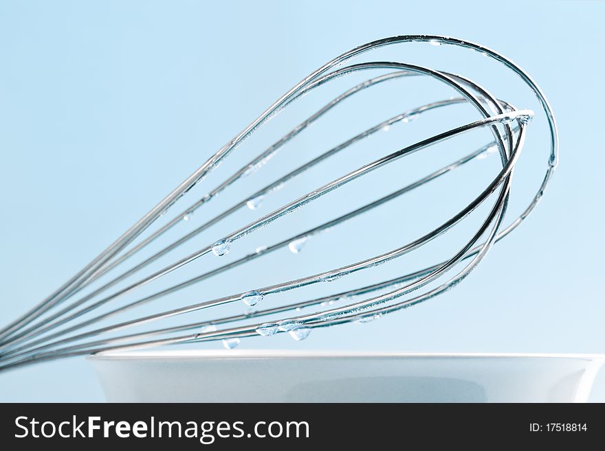 Kitchen whisk on top of bowl