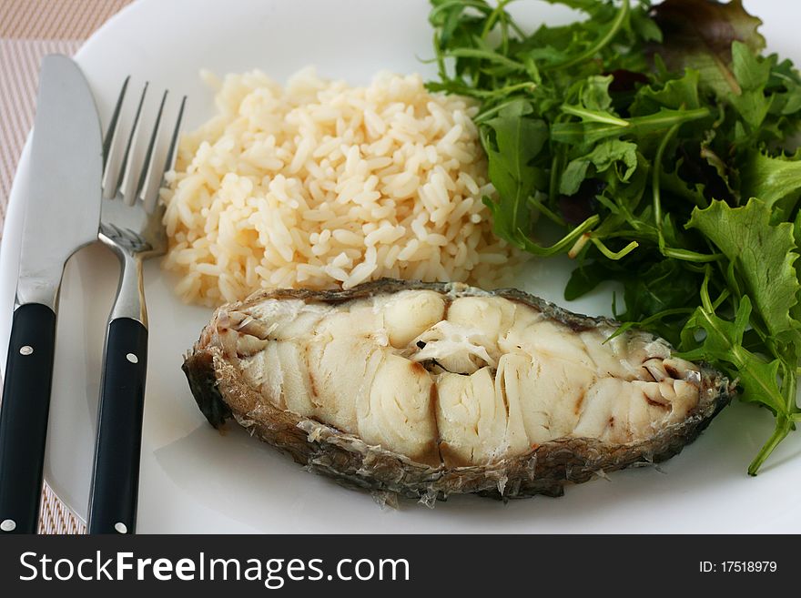 Boiled fish with rice and salad