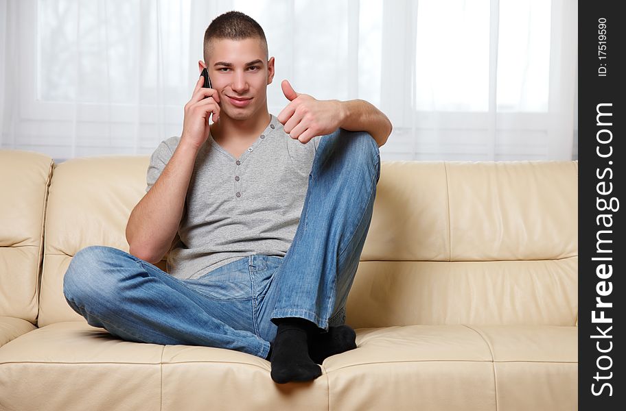 Young man using his telephone. Young man using his telephone