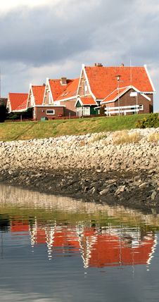 Houses With Red Roofs Reflected In The Water Stock Photography