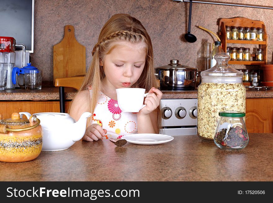 Girl Blowing To Cup Of Hot Drink