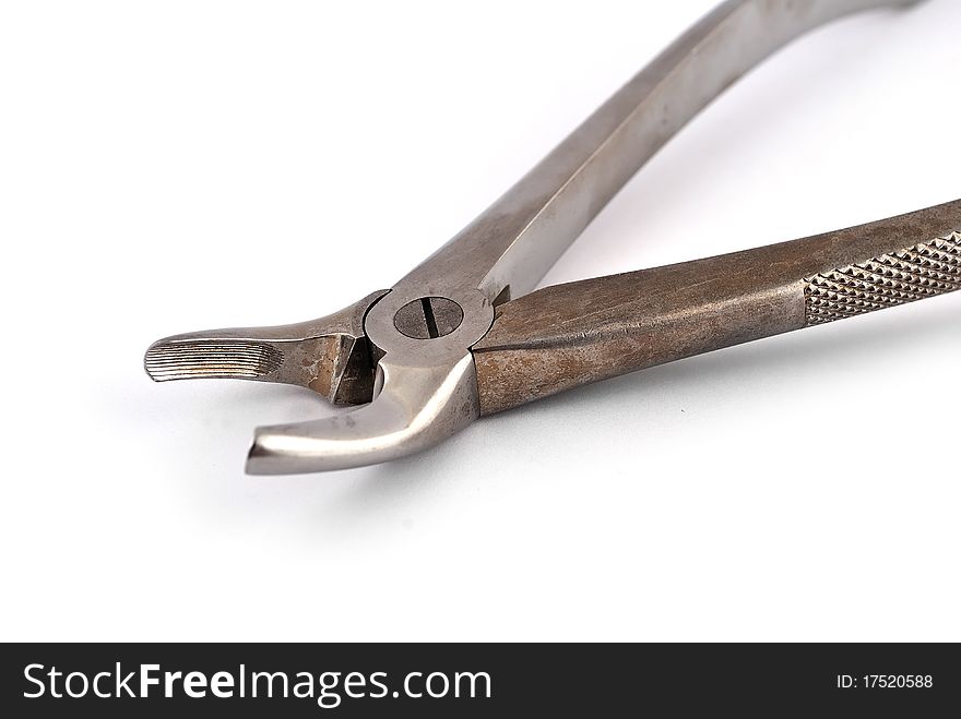 Old dental pliers on a white background