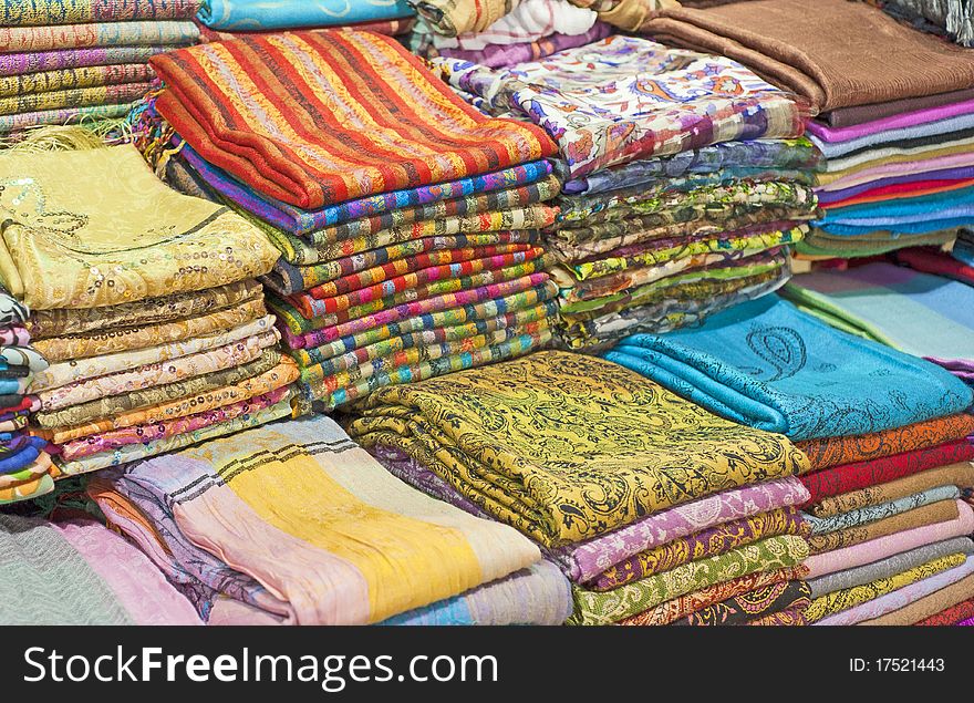 Fabrics and scarves for sale at a market stall. Fabrics and scarves for sale at a market stall