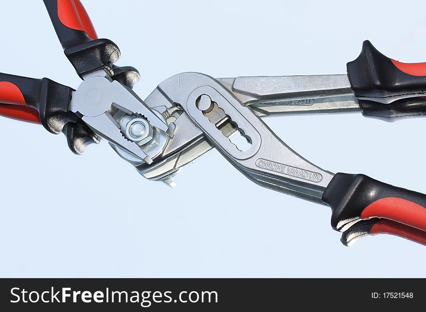 Macro of two pliers with mirror reflection. Macro of two pliers with mirror reflection