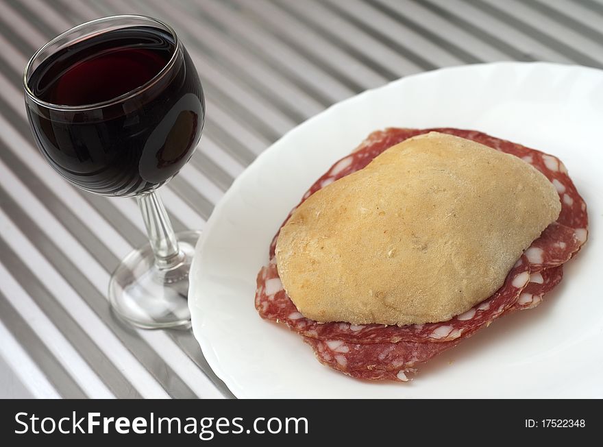 Sandwich with ham and a cup of red wine. Sandwich with ham and a cup of red wine