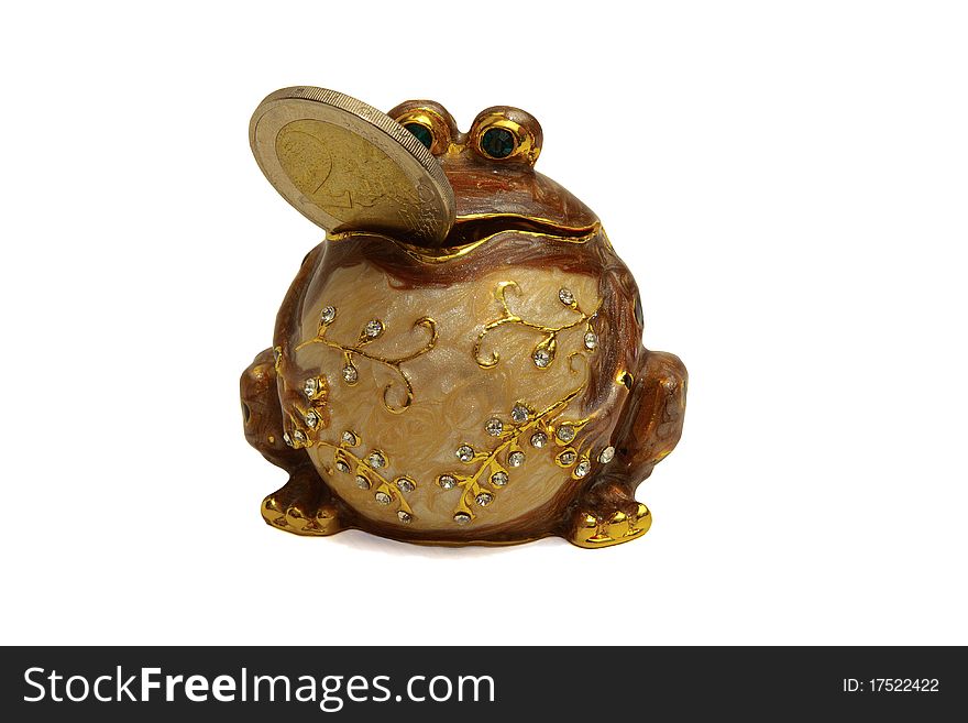 The figurine of a frog inlaid with crystals, with a coin in a mouth. The figurine of a frog inlaid with crystals, with a coin in a mouth.