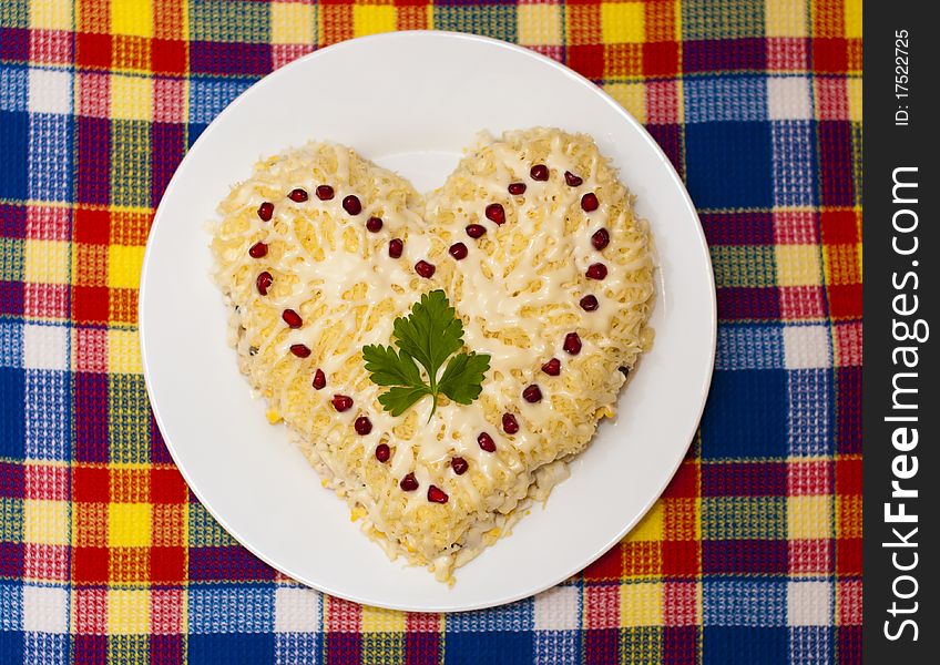 Shape of heart of salad on a white plate