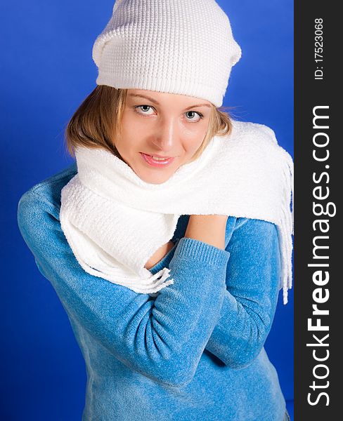 Young merry woman in a beret on a blue background. Young merry woman in a beret on a blue background