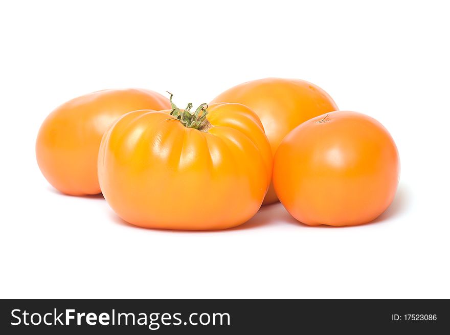Orange tomatoes closeup isolated on white background. Orange tomatoes closeup isolated on white background.