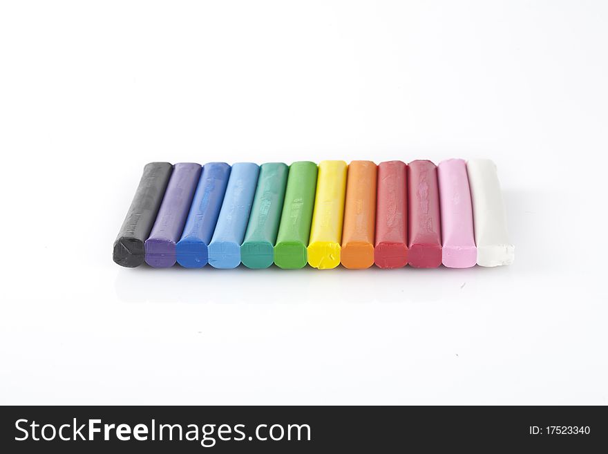 Various colors of modeling clay isolated on white