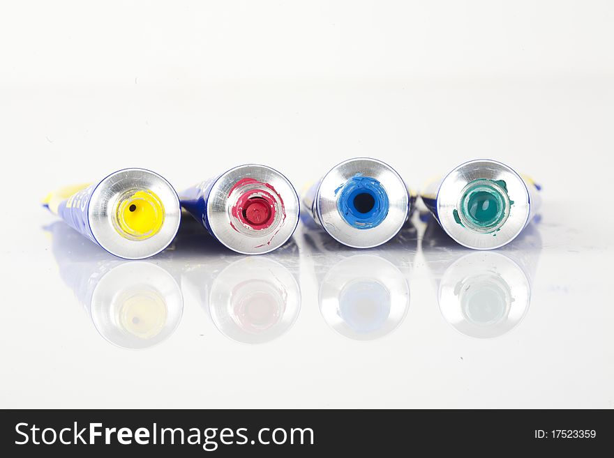 Messy paint tubes isolated on white