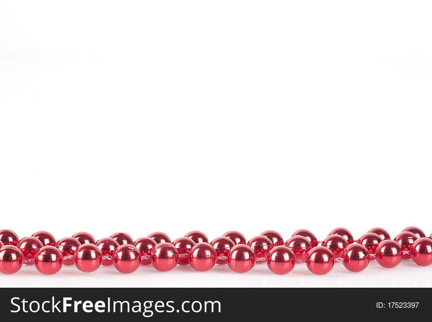 Red string with pearls with copy space. Ideal for Christmas. Isolated