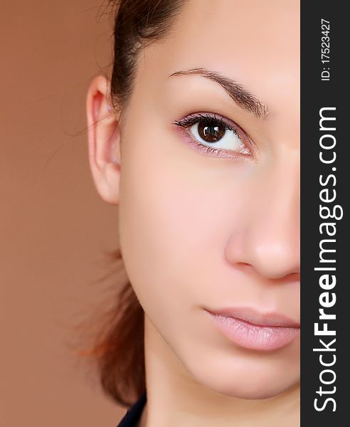 Closeup portrait of a half face of a young woman. Closeup portrait of a half face of a young woman