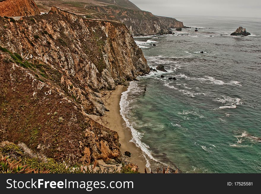 Waves hitting the rugged coastline in Big Sur California