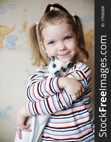 An image of a nice little girl with a toy-cat. An image of a nice little girl with a toy-cat