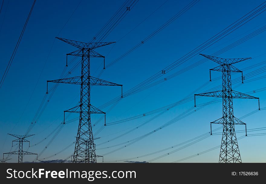 Electrical transmission towers carrying high voltage lines. Electrical transmission towers carrying high voltage lines.