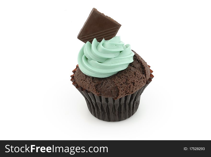Cup cake with green cream on white background.