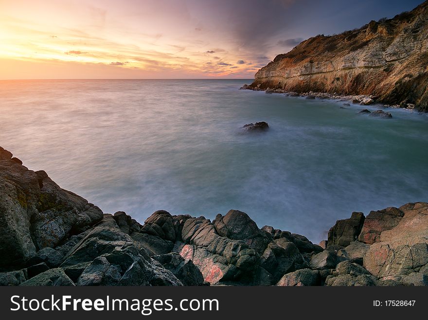 Beautiful seascape. Sea and rock at the sunset. Nature composition.