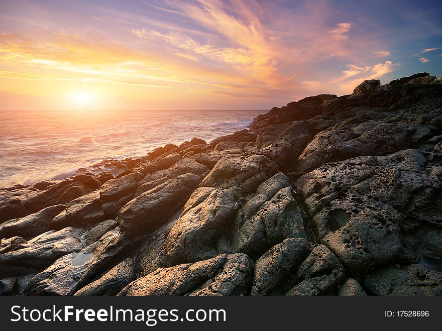 Beautiful seascape. Sea and rock at the sunset. Nature composition.