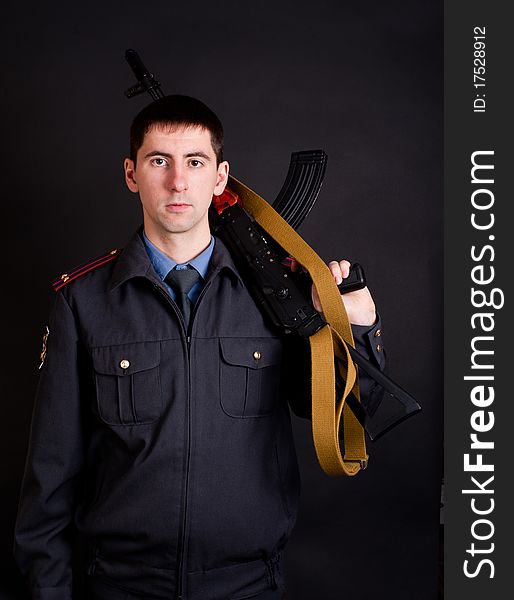 Man in uniform holding gun. Man in uniform holding gun