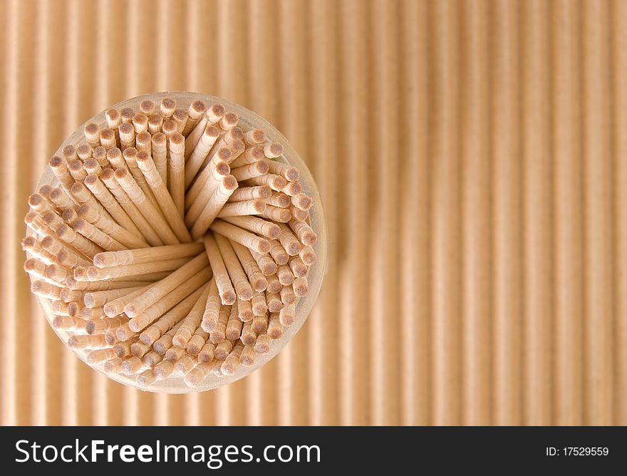 Packing of toothpicks on a cardboard background