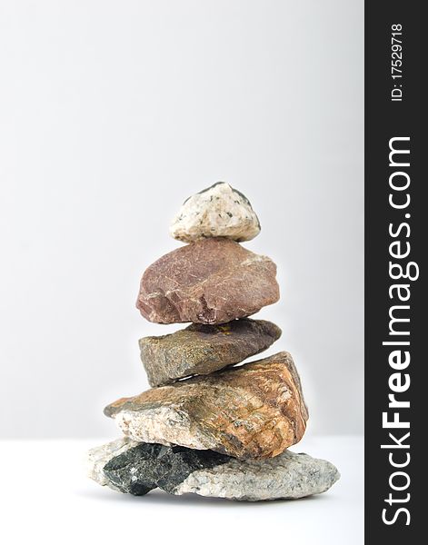 Balancing stones on a gray gradient background