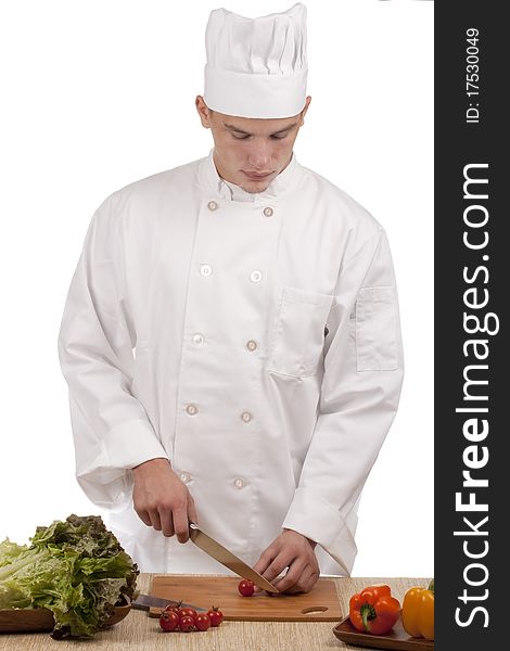 Chef Man cut vegetables on kitchen blackboard.