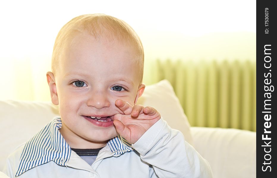 Smiling caucasian child biting with his finger in his mouth. Smiling caucasian child biting with his finger in his mouth