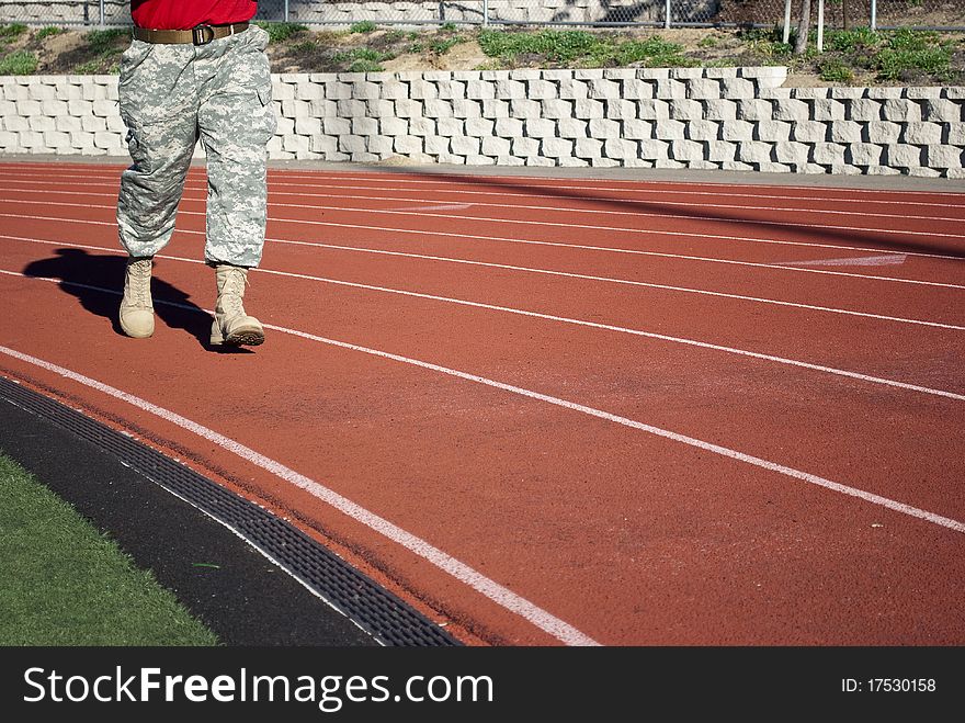 Training soldier in the army ammunition on the treadmill stadium.