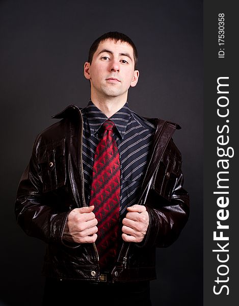 Young man in black shirt and red tie