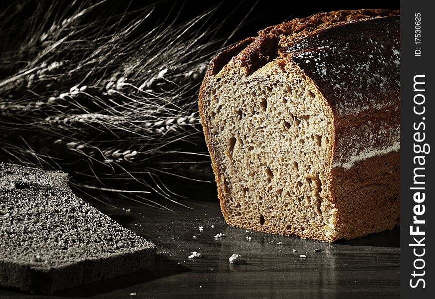 The black and white image shows slices of bread, cereals and a colored loaf of bread