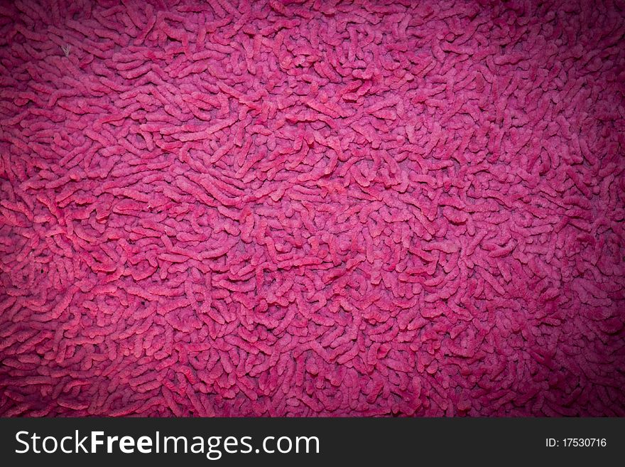 A big pink carpet fibers. To wipe out foot. A big pink carpet fibers. To wipe out foot
